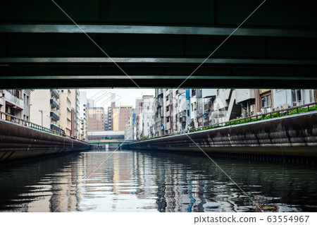 Namba street with canal under bridge in Osaka, Japan Namba street with canal under bridge in Osaka, Japan 63554967
