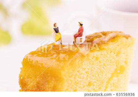 Two women arriving at the table with pineapple cake Two women arriving at the table with pineapple cake 63556936
