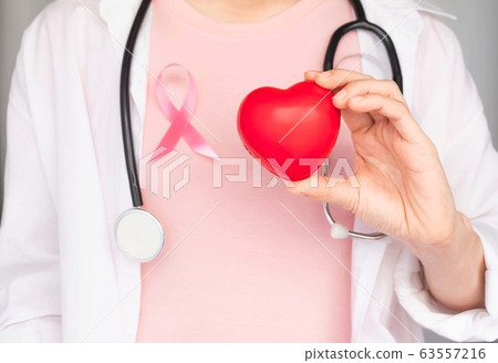World Breast Cancer Day Concept,health care - woman wore pink t-shirt,Pink ribbon for breast cancer awareness, symbolic bow color raising awareness on people living with women's breast tumor illness 63557216