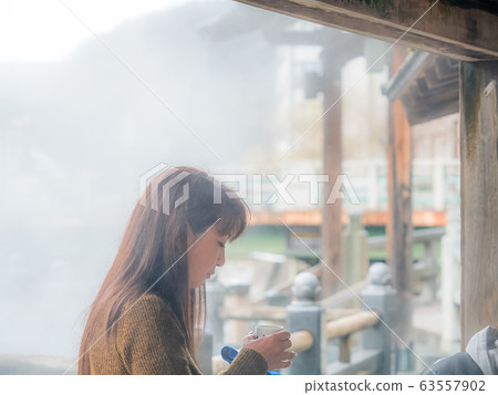 Hot spring town Women enjoying drinking spring Portrait Hot spring town Women enjoying drinking spring Portrait 63557902
