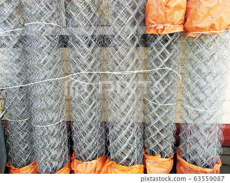 Construction grid a chain-link in rolls. Wicker fence metal bar fence, rabitz Construction grid a chain-link in rolls. Wicker fence metal bar fence, rabitz 63559087
