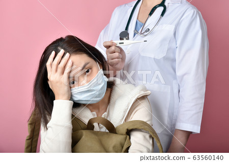 Asian woman backpacker get sick and high fever 63560140
