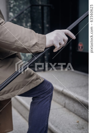 Man hand in plastic glove virus protection 63560625