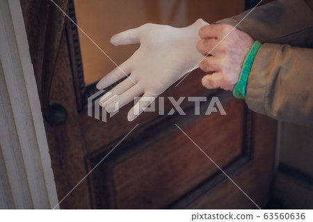 Man hand in plastic glove virus protection 63560636