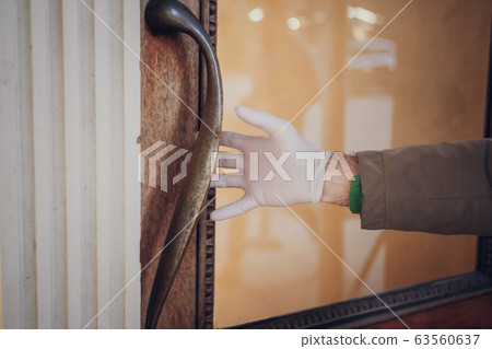 Man hand in plastic glove virus protection 63560637