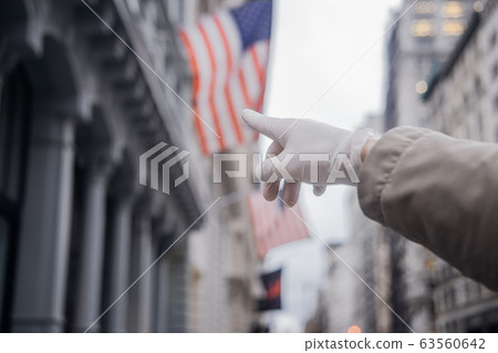 Man hand in ruber glove aganst American flag 63560642