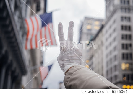 Man hand in ruber glove aganst American flag 63560643