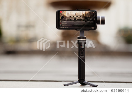 Phone with stabilizer, tripod, gimbal taking photo 63560644