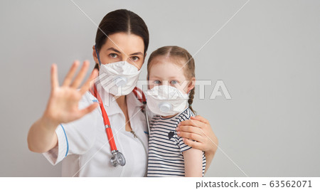 Doctor and child wearing facemasks 63562071