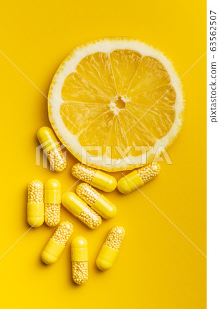 Vitamin capsules. Vitamin C pills and slice of Vitamin capsules. Vitamin C pills and slice of 63562507