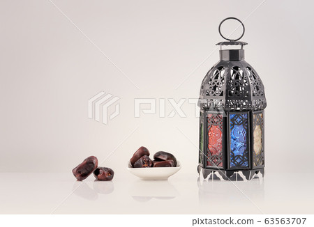 Ornamental Arabic lantern with burning candle 63563707
