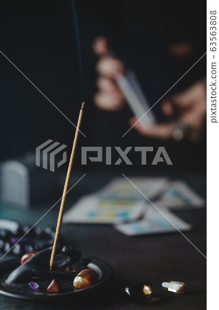 Tarot cards are surrounded magic things on a table.Mystical and occult concept Tarot cards are surrounded magic things on a table.Mystical and occult concept 63563808