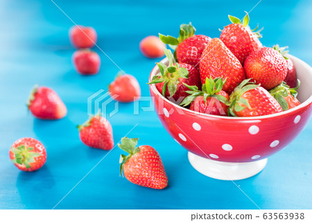 strawberries in a colorful bowl on a colorful background 63563938