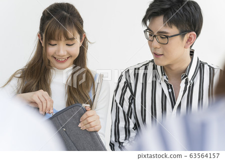 Young man and woman taking out PC 63564157