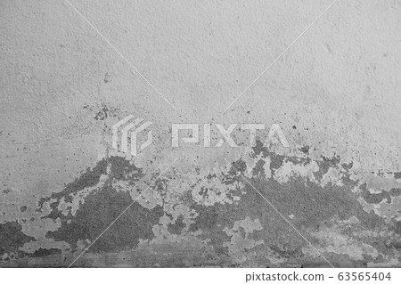 Close-up of White cement crack wall and peeled paint caused by water and sunlight. Peel wall of White house paint with black stain. Black and White of Texture background. 63565404