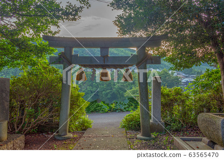 Summer morning view of Torii gate at Imohoritogoro shinto shrine, Yamashina, Kanazawa, Ishikawa prefecture, Japan. The torii marks the separation between the profane world to the sacred world. 63565470