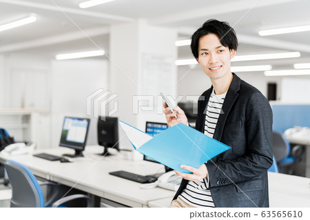 Young businessman (office, smartphone, file, office casual Young businessman (office, smartphone, file, office casual 63565610