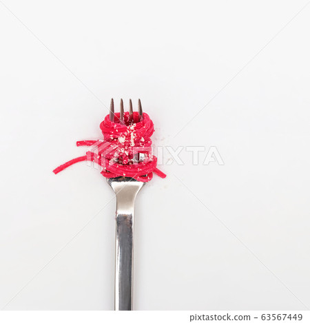 Spaghetti pasta with pink beetroot sause on a fork 63567449