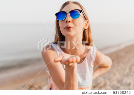 Young girl posing standing on the beach on a Sunny 63568243