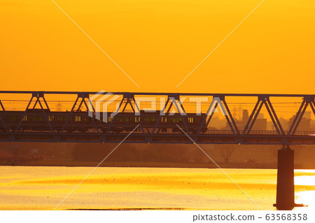 Keio Line passing the morning glow and Tamagawa Bridge 63568358