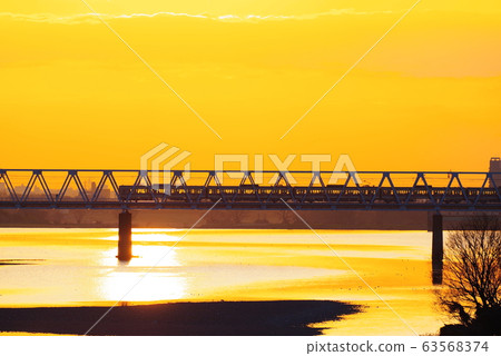 Keio Line passing the morning glow and Tamagawa Bridge 63568374