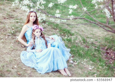 Portrait of a beautiful mother and daughter near a Portrait of a beautiful mother and daughter near a 63568947