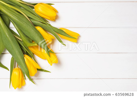 Bouquet of fresh bright spring tulips on white wooden background with copy space. 63569628