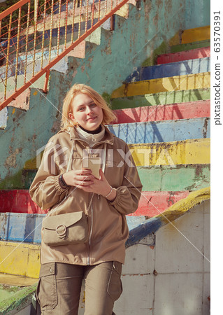 Woman with smartphone near the rainbow stairs. Woman with smartphone near the rainbow stairs. 63570391