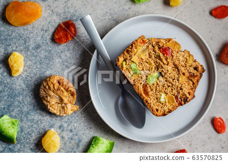 Piece of dried fruit bread on a gray plate Piece of dried fruit bread on a gray plate 63570825