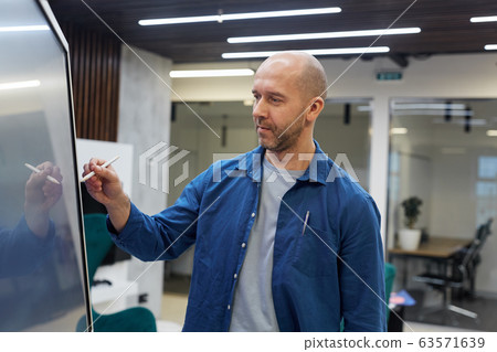 Bald Adult Mann Using Digital Screen Board Bald Adult Mann Using Digital Screen Board 63571639