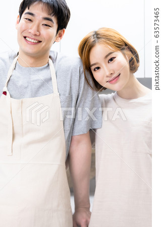 Newlyweds cooking kitchen Newlyweds cooking kitchen 63573465
