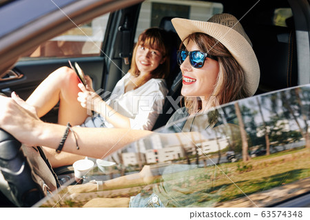 Pretty smiling woman driving car Pretty smiling woman driving car 63574348