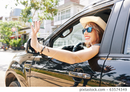 Woman looking out of car window Woman looking out of car window 63574349