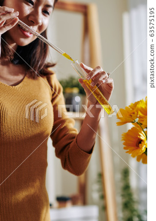 Woman working with diluted colorant Woman working with diluted colorant 63575195