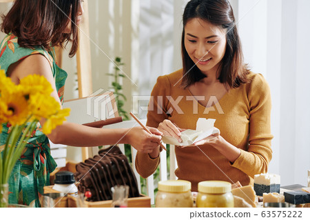 Women choosing paper for handmade soap Women choosing paper for handmade soap 63575222