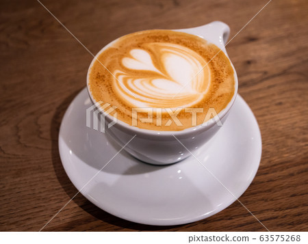 A coffee with a beautiful latte art heart on top A coffee with a beautiful latte art heart on top 63575268