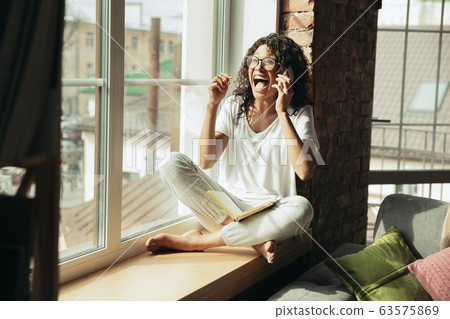 African-american woman, freelancer during the work in home office while quarantine 63575869