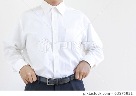 A man in a shirt repairing his pants 63575931