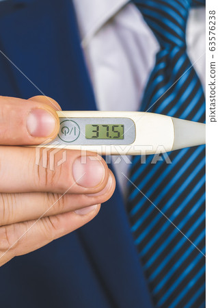 A man in a suit and tie holds in his hands an 63576238