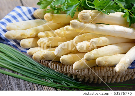 Fresh white asparagus from Germany with parsley and chives 63576770