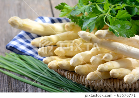 Fresh white asparagus from Germany with parsley and chives 63576771