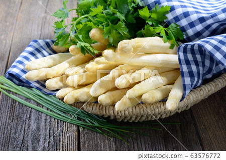Fresh white asparagus from Germany with parsley and chives 63576772
