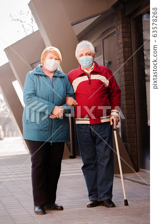 An elderly couple of people in masks An elderly couple of people in masks 63578268