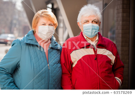 an elderly couple in protective masks an elderly couple in protective masks 63578269