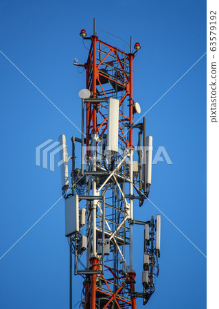 Telecommunication tower of 4G and 5G cellular. Cell Site Base Station. Wireless Communication Antenna Transmitter. Telecommunication tower with antennas against blue sky. Telecommunication tower of 4G and 5G cellular. Cell Site Base Station. Wireless Communication Antenna Transmitter. Telecommunication tower with antennas against blue sky. 63579192