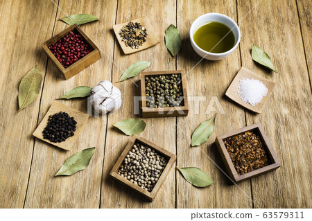 spices for a tasty meal on an old wooden table spices for a tasty meal on an old wooden table 63579311