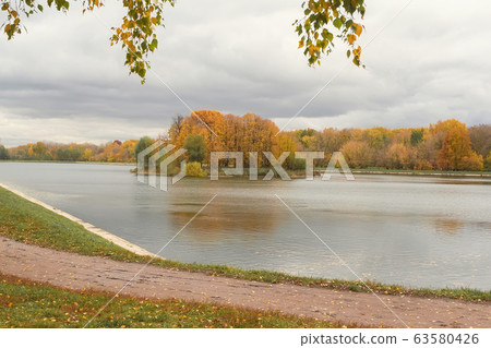 Autumn landscape, island in the lake, panorama of island with trees in autumn colors. Colorful autumn scenery 63580426