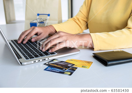 Woman using credit card register security code Woman using credit card register security code 63581430