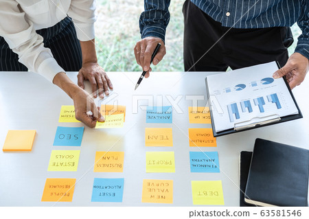 Two creative business people meeting and planning 63581546
