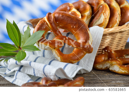 Fresh Bavarian pretzels in a breadbasket on a wooden table Fresh Bavarian pretzels in a breadbasket on a wooden table 63581665